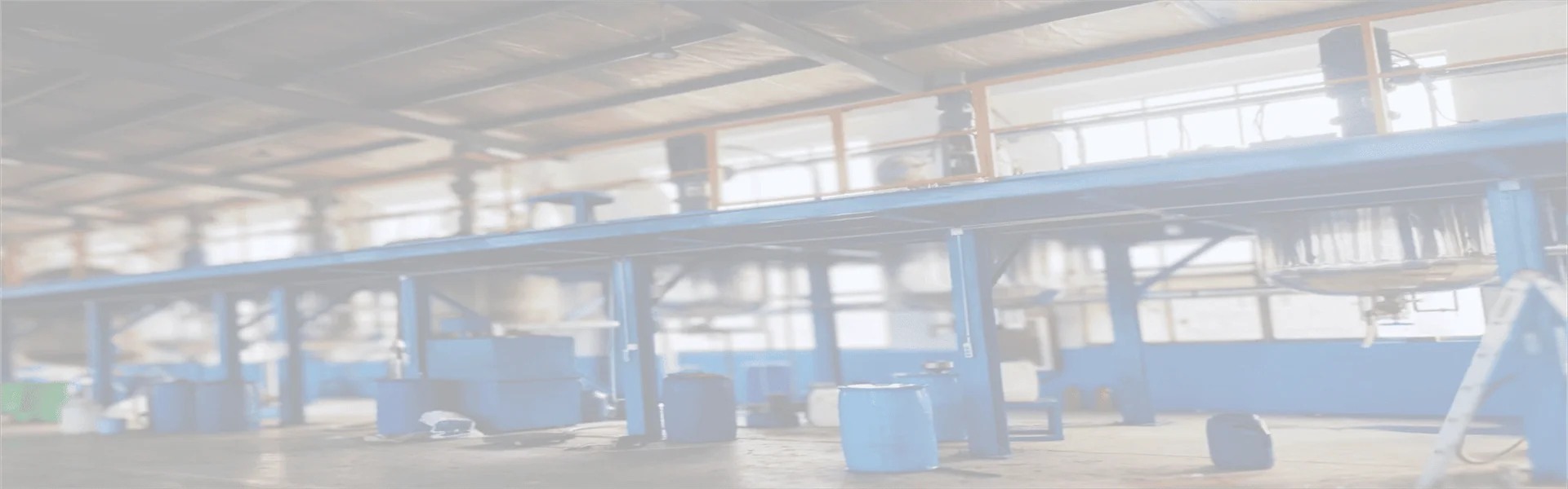 A wide shot of INVINO chemical formulation facility with raw material storage tanks for pulp, paper, and construction antifoams.